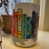 White mug with rainbow children's books